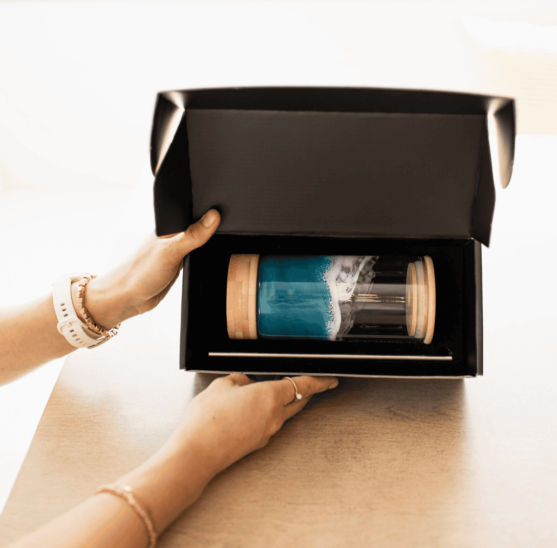 Ocean Vibes resin glass tumbler with bamboo lid and metal straw packaged in a Lynn & Liana black gift box