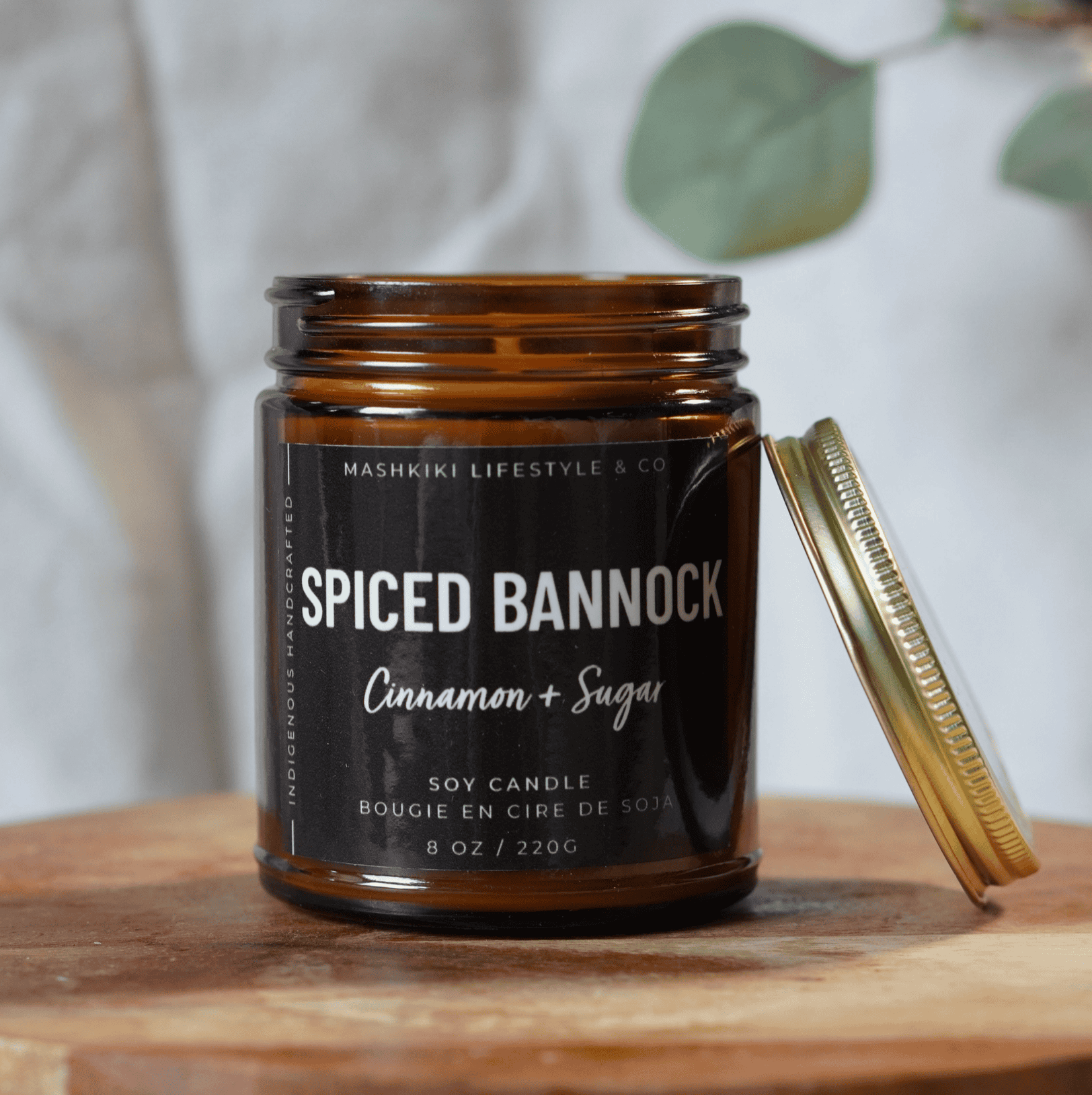 Mashkiki Spiced Bannock 8 oz amber glass soy candle in Cinnamon + Sugar with a gold metal lid