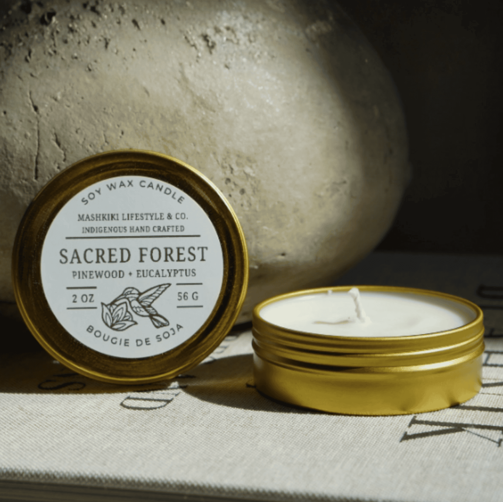 Mashkiki Sacred Forest 2 oz soy candle in a gold tin, Pinewood + Eucalyptus, lid off
